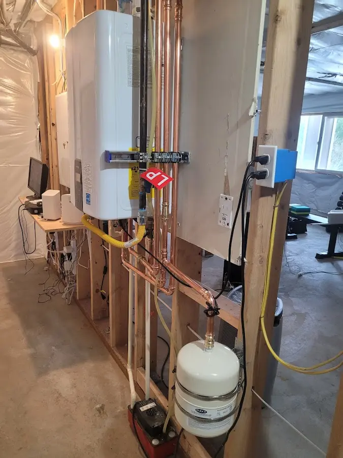 Licensed plumber repairing a kitchen sink in East Haven